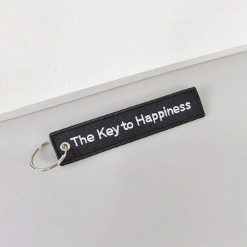 Breloc moto textil "The key to happiness" brodat Breloc moto textil "The key to happiness" brodat